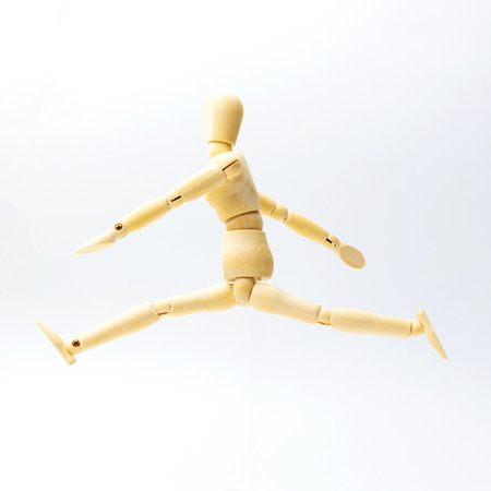 Wooden figure doll with jumping emotion for success business concept on white background.の写真素材