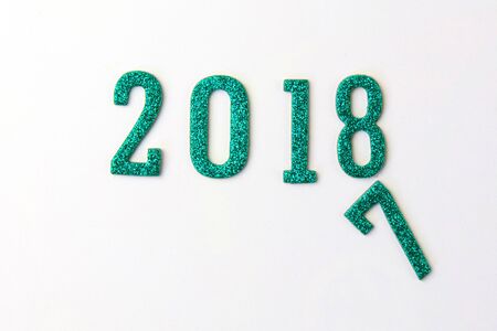 2018 New year concept. Group of businessman and business woman miniature figures sitting on 2 0 1 8 number wooden block toy on world map.の写真素材