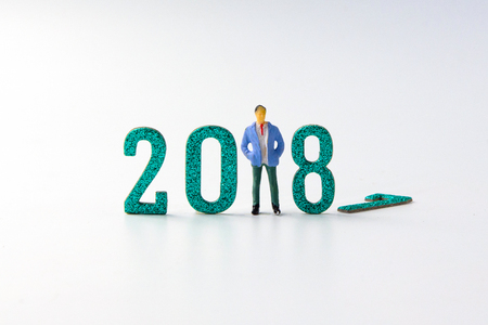 2018 New year concept business man miniature figures standing on 2 0 1 8 number on white background.の写真素材