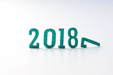 2018 New year concept. Group of businessman and business woman miniature figures sitting on 2 0 1 8 number wooden block toy on world map.の写真素材