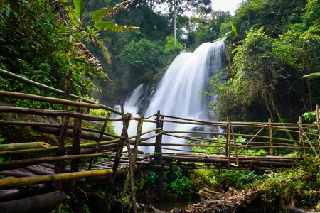 beautiful waterfall in northern Thailand, name Pha dok siew waterfall in Doi intanon national park with bamboo bridge.の写真素材