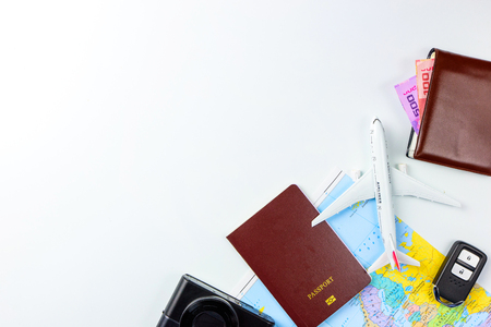 Travel accessories costumes concept for summer vacation trip. Passports, luggage, map, smartphone,sun glasses,camera, note pad, jean on white.の写真素材