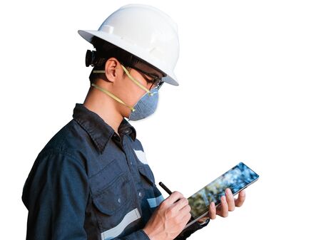 Asian Engineer wearing face mask N95 protect filter pm2.5 anti pollution, anti smog and viruses. Air pollution, working with tablet concept isolated on white background.の写真素材
