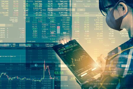 Double exposure of business woman wearing Mask holding tablet for check stock market graph with flare light, Protection against contagious disease, coronavirus Business Trading concept.の写真素材