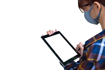 Protection against contagious disease, coronavirus. Asian Engineer woman or worker wearing hygienic mask N95 to prevent infection,airborne respiratory illness as flu,2019-nCoV,used tablet isolated.の写真素材