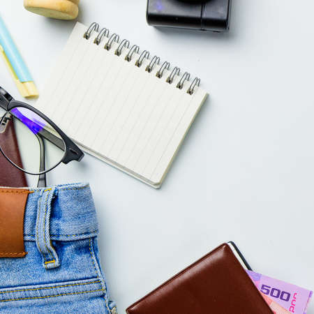 Travel accessories costumes concept for summer vacation trip. Passports, luggage, map, smartphone,sun glasses,camera, note pad, jean on white.の写真素材