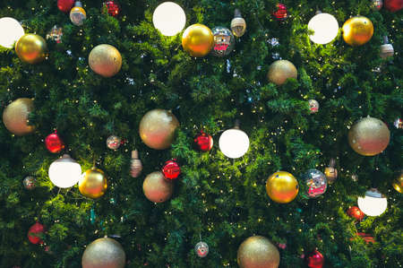 Decorated Christmas tree and New Year holidays  sparking, glowing. Happy New Year theme Blurred bokeh background.の写真素材