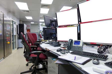 Side view of blank monitors in control room for control plant process or trade stock market.の写真素材