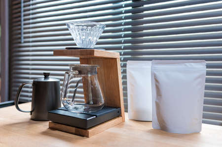 Hand drip coffee, Barista making drip coffee with mockup blank package coffee Alternative ways of brewing Coffee shop concept.の写真素材