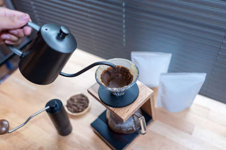 Hand drip coffee, Barista making drip coffee with mockup blank package coffee Alternative ways of brewing Coffee shop concept.の写真素材