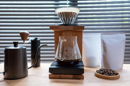 Hand drip coffee, Barista making drip coffee with mockup blank package coffee Alternative ways of brewing Coffee shop concept.の写真素材
