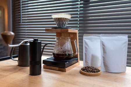 Hand drip coffee, Barista making drip coffee with mockup blank package coffee Alternative ways of brewing Coffee shop concept.の写真素材