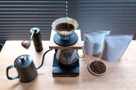 Hand drip coffee, Barista making drip coffee with mockup blank package coffee Alternative ways of brewing Coffee shop concept.の写真素材