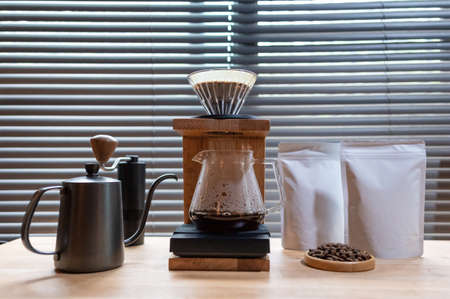 Hand drip coffee, Barista making drip coffee with mockup blank package coffee Alternative ways of brewing Coffee shop concept.の写真素材