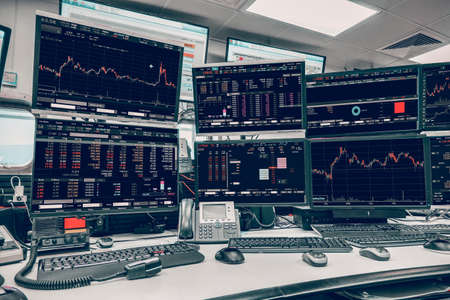 group of stock data monitor analyzing data stock market in monitoring room on the data presented in the chart, forex trading graph, stock exchange trading online, financial investment.の写真素材