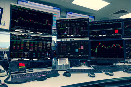 group of stock data monitor analyzing data stock market in monitoring room on the data presented in the chart, forex trading graph, stock exchange trading online, financial investment.の写真素材