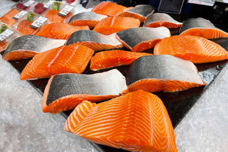 Fresh salmon fillet on ice in supermarket.の写真素材