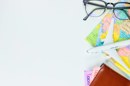 Travel accessories costumes concept for summer vacation trip. Passports, luggage, map, smartphone,sun glasses,camera, note pad, jean on white.の写真素材
