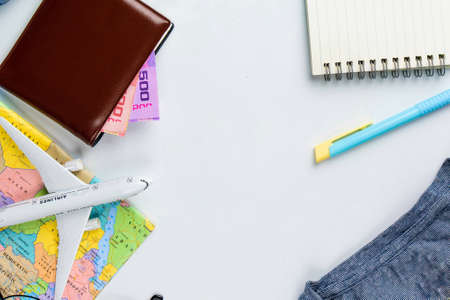 Travel accessories costumes concept for summer vacation trip. Passports, luggage, map, smartphone,sun glasses,camera, note pad, jean on white.の写真素材