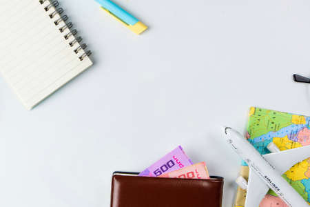 Travel accessories costumes concept for summer vacation trip. Passports, luggage, map, smartphone,sun glasses,camera, note pad, jean on white.の写真素材