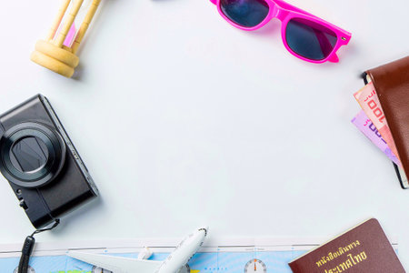 Travel accessories costumes concept for summer vacation trip. Thailand Passports, luggage, map, smartphone,sun glasses,camera, note pad, jean on white.の写真素材