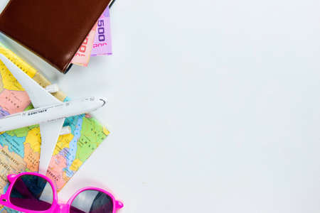Travel accessories costumes concept for summer vacation trip. Thailand Passports, luggage, map, smartphone,sun glasses,camera, note pad, jean on white.の写真素材