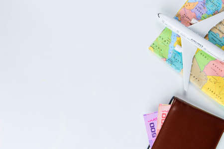 Travel accessories costumes concept for summer vacation trip. Thailand Passports, luggage, map, smartphone,sun glasses,camera, note pad, jean on white.の写真素材