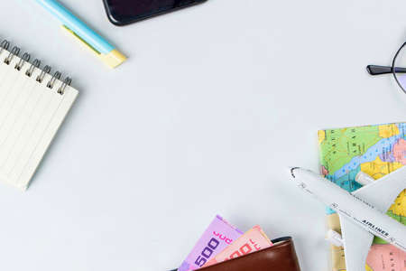 Travel accessories costumes concept for summer vacation trip. Thailand Passports, luggage, map, smartphone,sun glasses,camera, note pad, jean on white.の写真素材