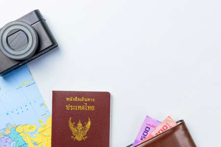 Travel accessories costumes concept for summer vacation trip. Thailand Passports, luggage, map, smartphone,sun glasses,camera, note pad, jean on white.の写真素材