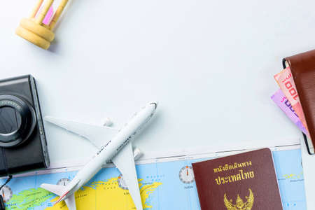 Travel accessories costumes concept for summer vacation trip. Thailand Passports, luggage, map, smartphone,sun glasses,camera, note pad, jean on white.の写真素材