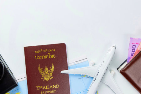 Travel accessories costumes concept for summer vacation trip. Thailand Passports, luggage, map, smartphone,sun glasses,camera, note pad, jean on white.の写真素材