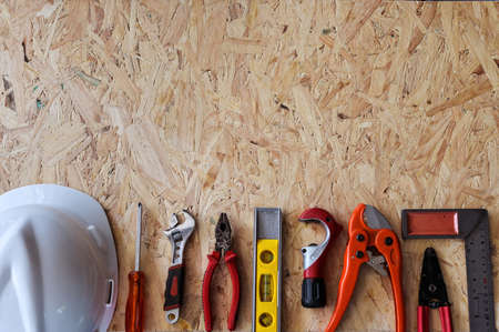 Different construction tools with Hand tools for home renovation on wooden board maintenance and reparing concept.の写真素材