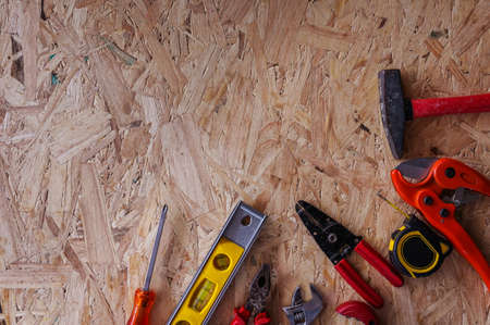 Different construction tools with Hand tools for home renovation on wooden board maintenance and reparing concept.の写真素材