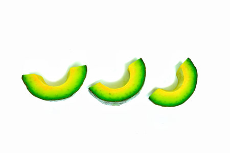 Avocado.Fruit.Fresh green color.High in vitamins.Sliced.Sliced.Laying on a white background.