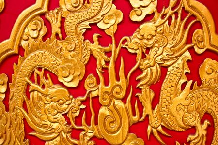 chinese dragons on red texture, temple in thailandの写真素材