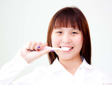 cute asian woman cleaning her toothの写真素材