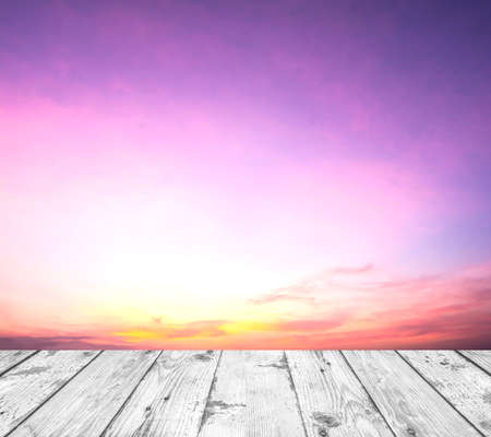 old white painted wood in front of sky with clouds in the eveningの写真素材