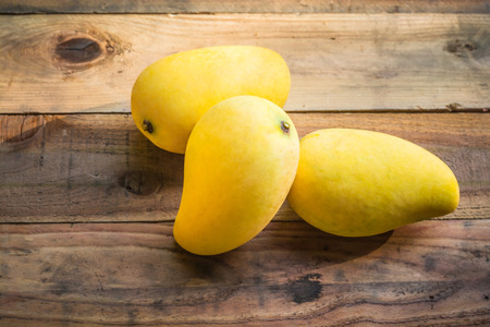 mango is ripe on old wooden tableの写真素材