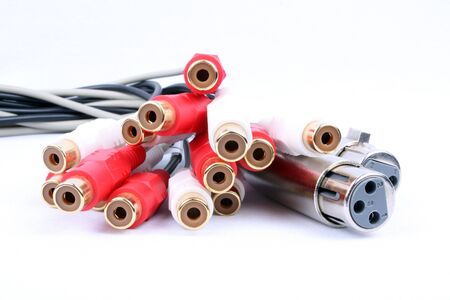 A view of different connection pins in a breakout cable used in a music studio, isolated on a white fabric.の写真素材