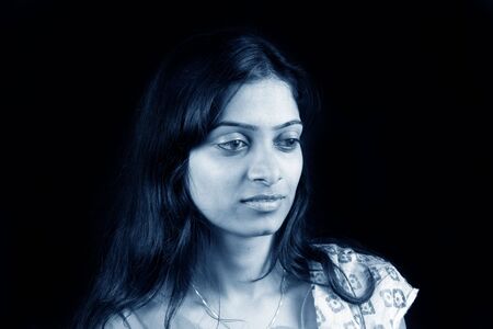 A portrait of a beautiful Indian teenage model in blue tone.の写真素材