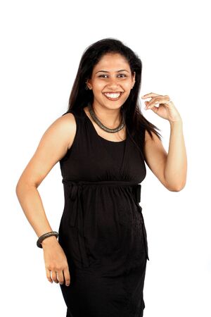 A jovial Indian woman dancing happily, on white studio background.の写真素材