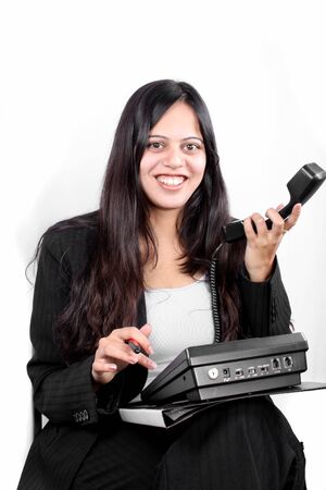 A smiling Indian businesswoman showing a phone without network connection or connecting cables to it.の写真素材