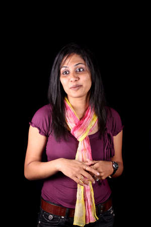 A portrait of a pretty Indian girl, on black studio background.の写真素材