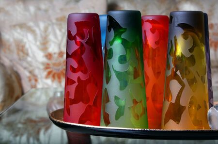 A set of beautiful colorful glasses on a table.の写真素材