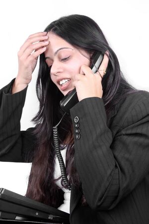 An Indian businesswoman facing problem in communicating with a client over a telephonic conversation.の写真素材