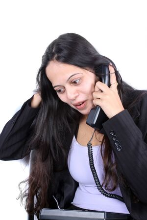 A beautiful Indian businesswoman talking on the phone.の写真素材