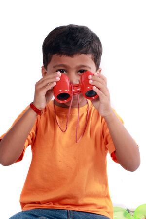A small indian boy with a pair of binoculars.の写真素材