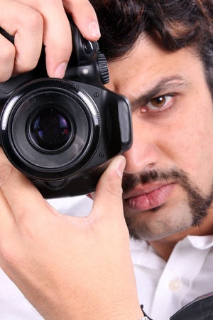A closeup video of an Indian photographer with focus on the camera.の写真素材