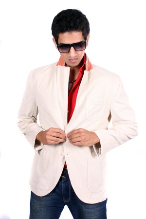 A stylish young Indian man dressing up for a party, on white studio background.の写真素材