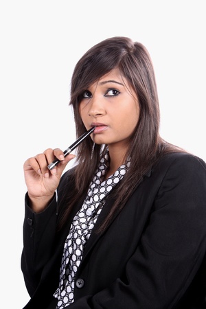A portrait of a tensed Indian businesswoman, on white studio background.の写真素材